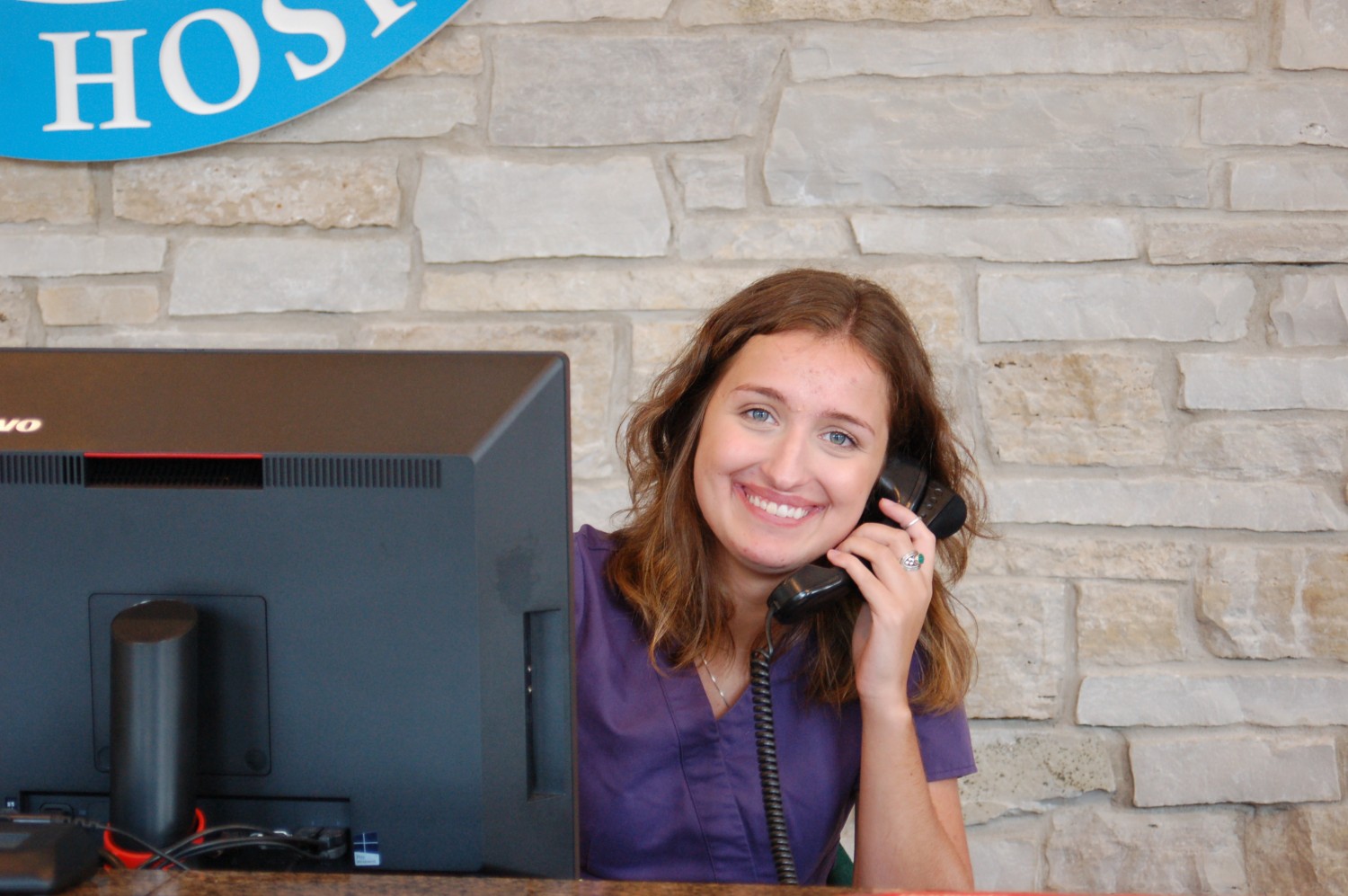Receptionist with phone - Call us any time!